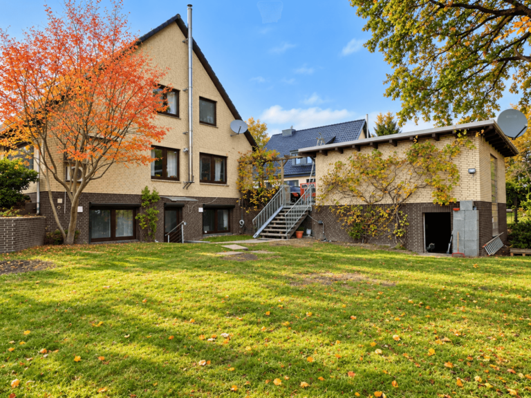 Haus mit Garage vom Garten aus